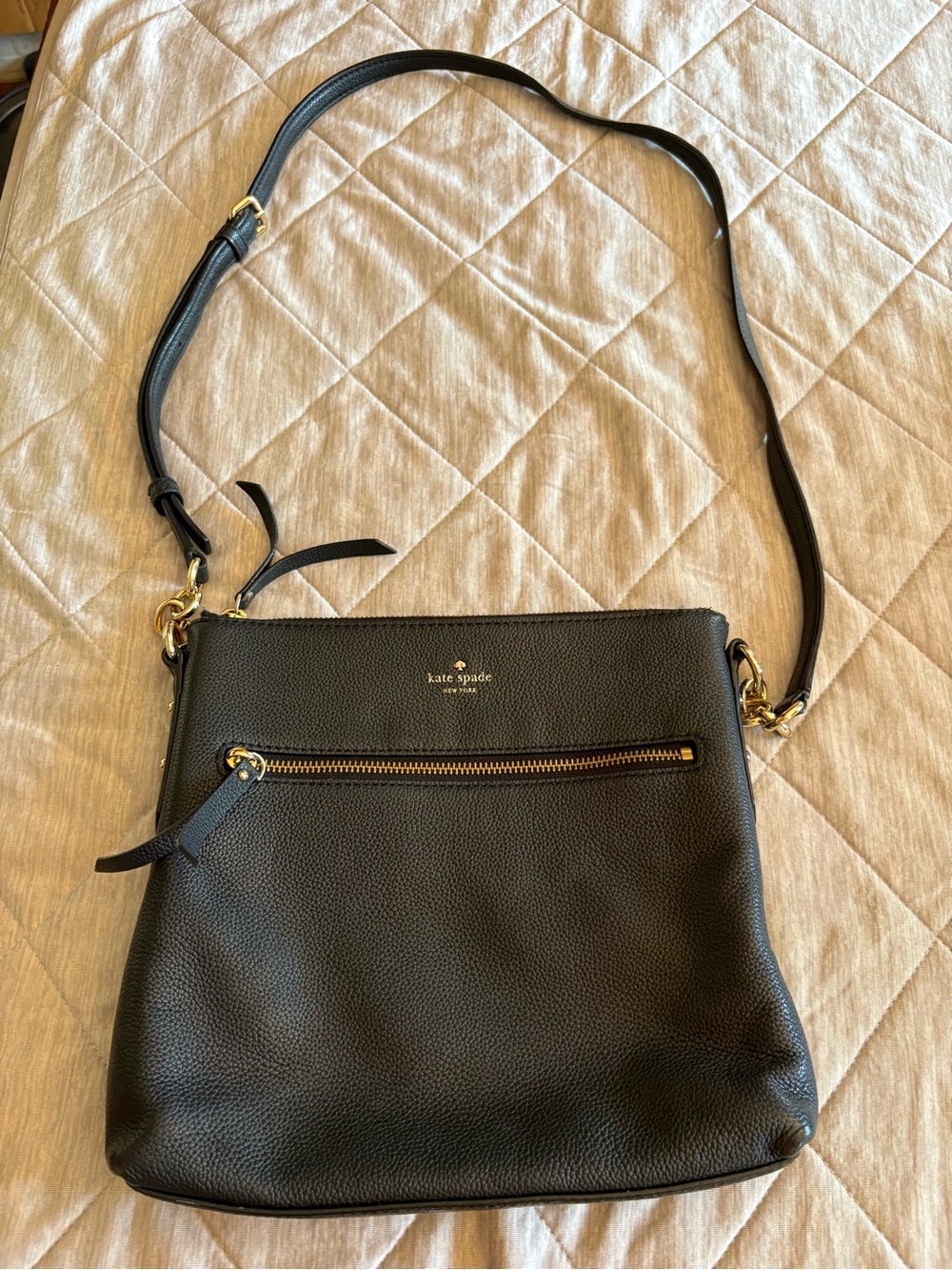 Kate Spade black pebble leather crossbody with gold hardware.